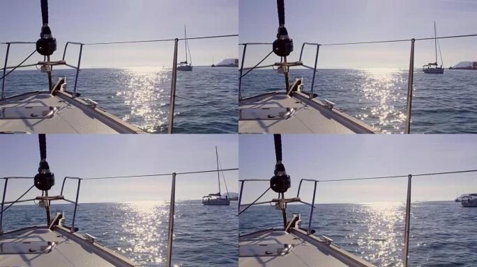 4k帆船在阳光明媚的蓝色海洋上行驶，实时
