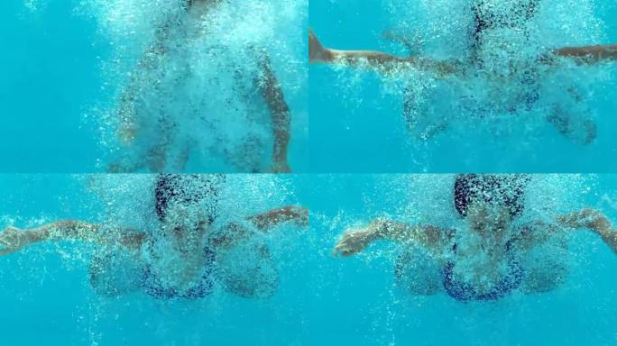 穿着蓝色泳衣漂浮在水下的黑发女人