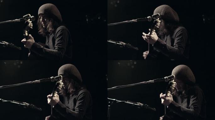 吉他手在舞台上弹唱。日本东京。