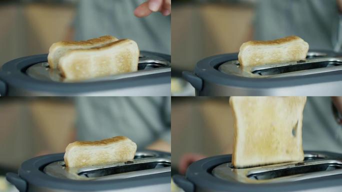 一个女人从烤面包机里拿吐司的特写镜头。