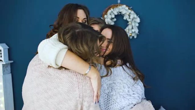 四个漂亮的女孩互相拥抱。女朋友在卧室里玩得开心，笑得开心
