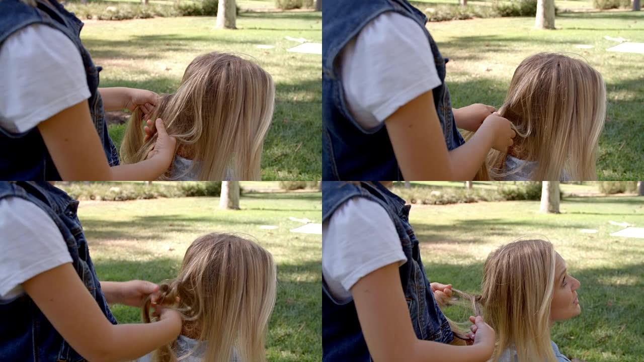 小女儿在公园编织母亲的头发
