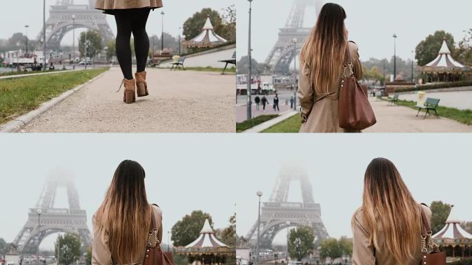 年轻美女在法国巴黎埃菲尔铁塔附近用手机聊天，分享印象