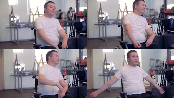 一位残疾人坐在轮椅上时伸展手臂和肩膀