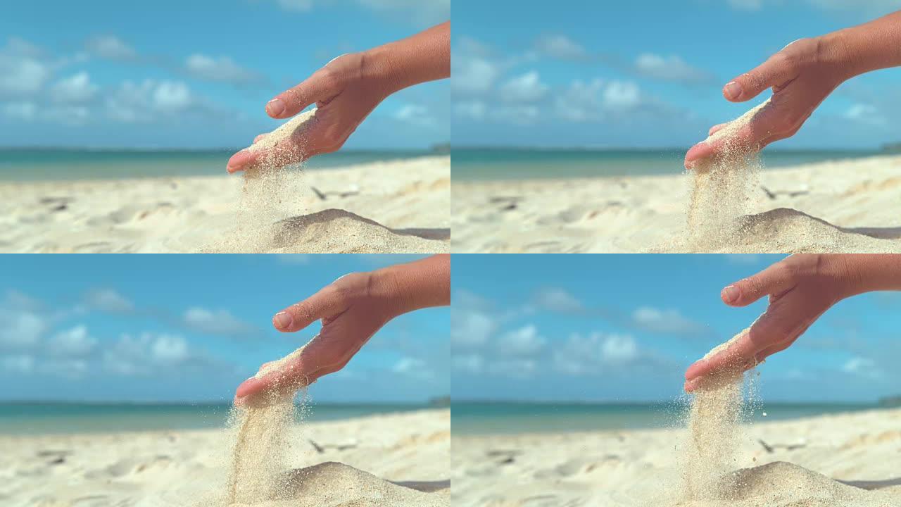 慢动作微小的沙粒被夏日的微风从女性手中扫走