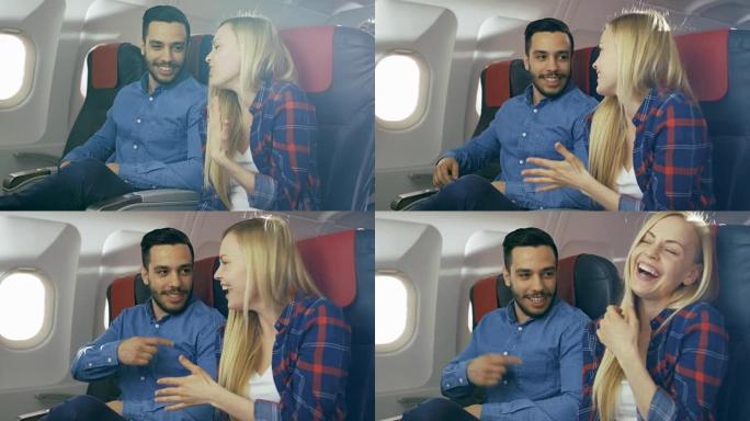 在商业飞机上，英俊的西班牙裔男子向他美丽的金发女友讲述了有趣的故事。两人都笑了。他们乘坐新飞机旅行，