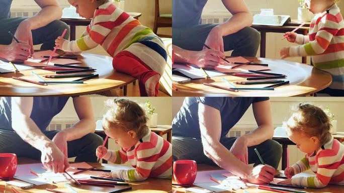 父亲和他的小儿子在客厅用彩色铅笔画画4k