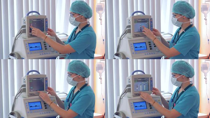 麻醉师在手术室用心电描记器工作。