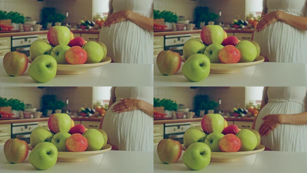 怀孕的苹果。孕妇吃健康午餐