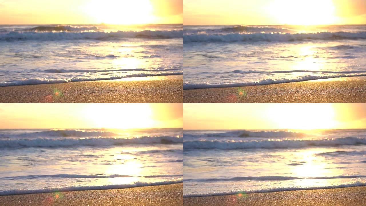 慢动作宏观: 漂亮闪闪发光的海洋挥舞着，冲刷着金色的沙滩