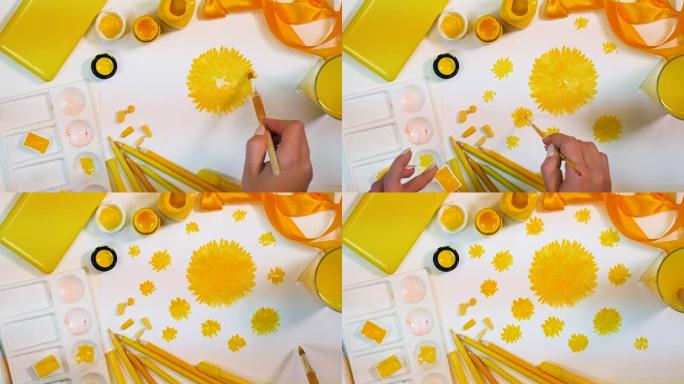 画的黄色花朵。艺术家书桌，黄色调色板。顶视图。