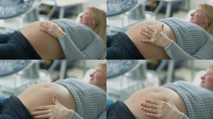 在医院里，聚焦镜头对准躺在床上的孕妇，抚摸她的腹部，感觉婴儿被踢。