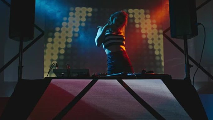 女性职业DJ跳舞和播放音乐