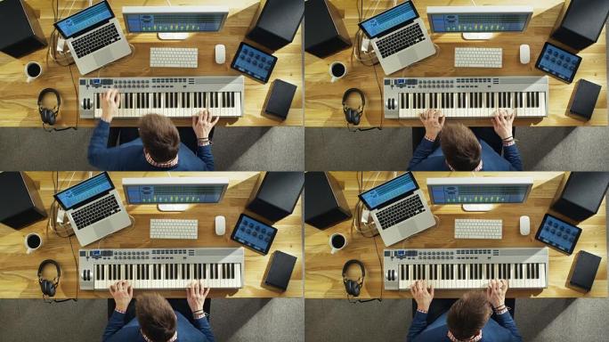 一位音乐家在他的工作室创作音乐，用音乐键盘演奏的俯视图。他的工作室阳光明媚，看起来很愉快。