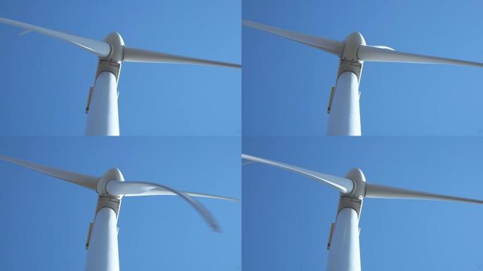 在晴朗的天空中工作的风力涡轮机
