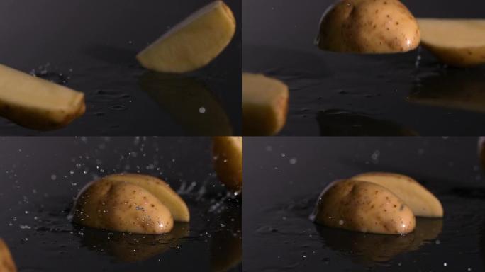 土豆碎片落在潮湿的黑色背景上