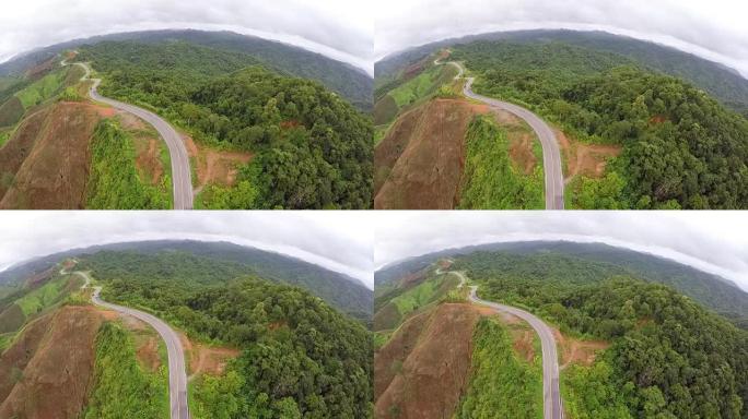 在山上蜿蜒的道路上的空中汽车。泰国。