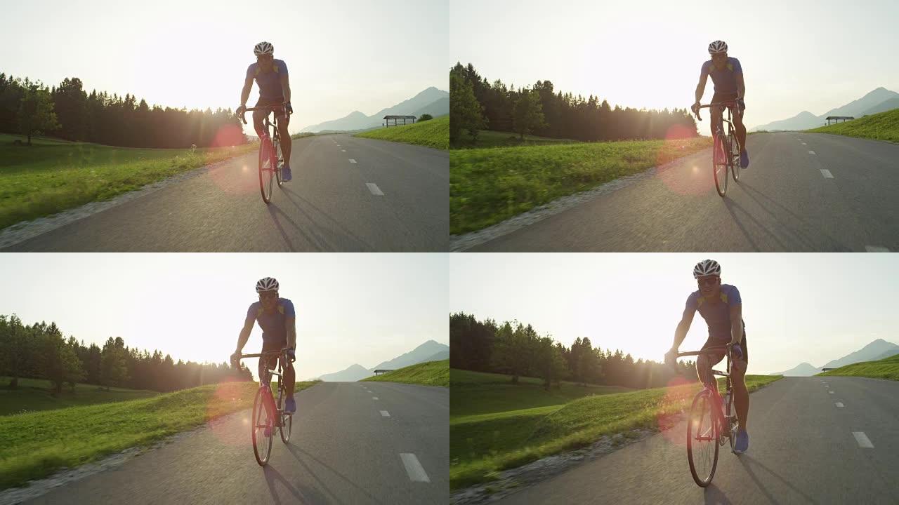 太阳耀斑: 金色的阳光照亮了骑着公路自行车的运动员。