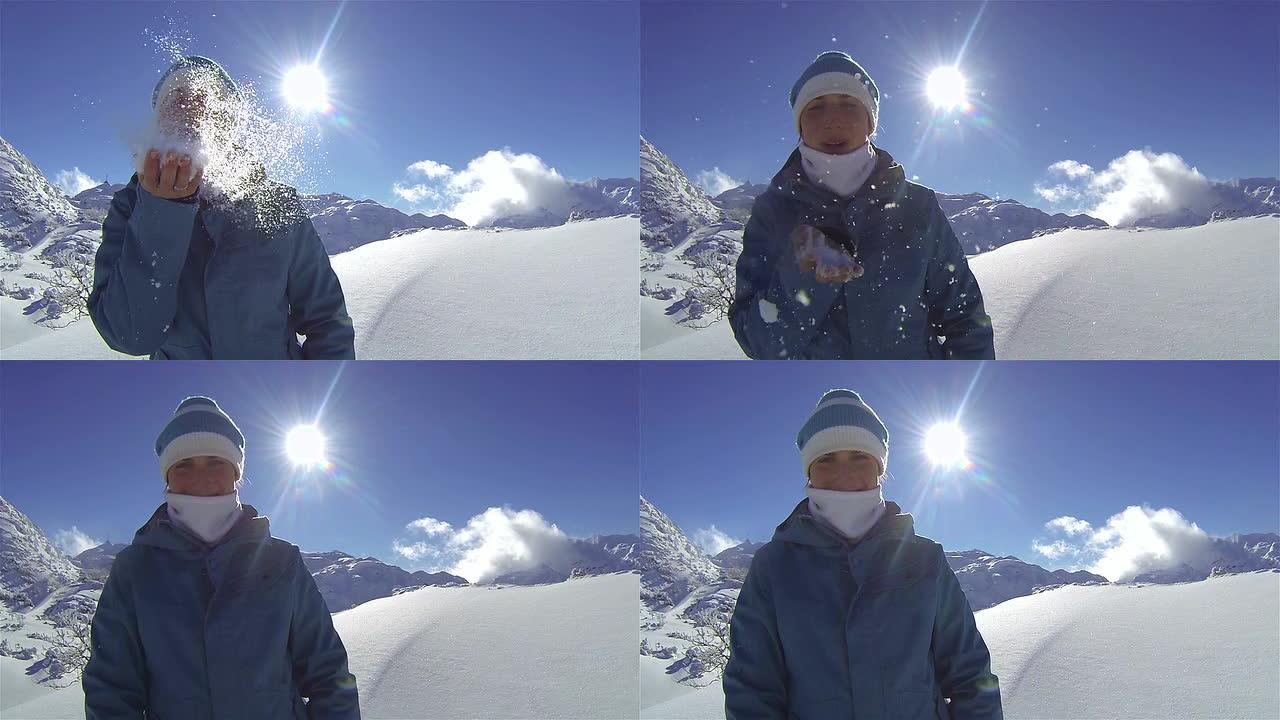 女人把雪花吹进相机