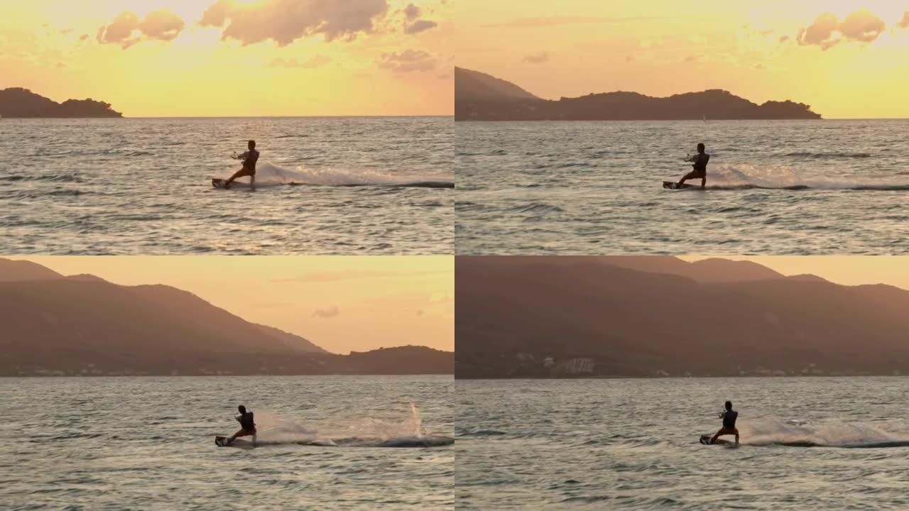 日落时在海湾冲浪的风筝冲浪者的SLO MO剪影