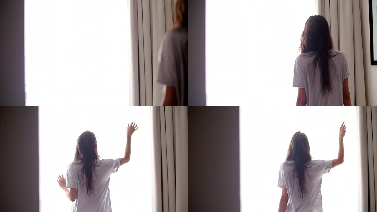 穿着男朋友衬衫的性感女人站在靠近窗户的地方
