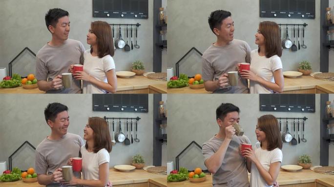 美丽幸福的亚洲夫妇正在厨房里一起喝一杯咖啡。男人和女人一边吃早餐一边聊天。年轻的亚洲夫妇在家里度过浪