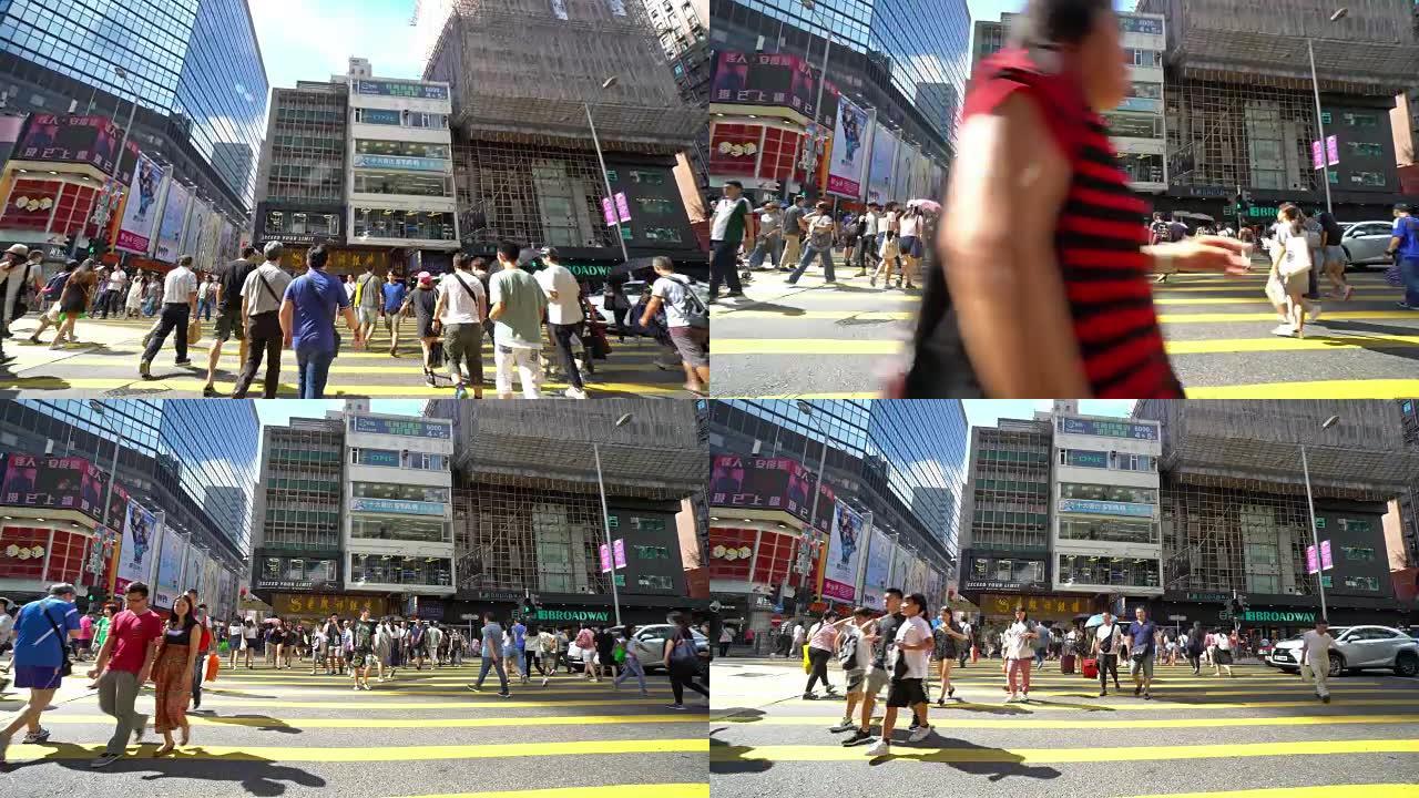 旺角地区繁忙的人行横道的4k镜头。旺角是香港九龙半岛西部油尖旺区的一个地区
