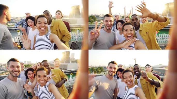 开朗的非裔美国女孩正在自拍调整相机，然后打电话给她的朋友，在屋顶派对上摆姿势并大笑。现代城市在背景中