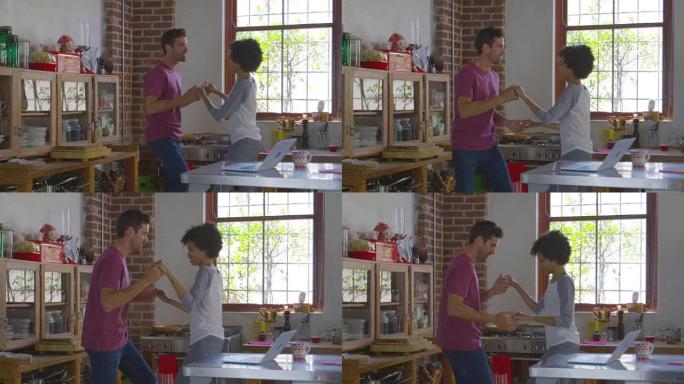 年轻的混血夫妇在厨房跳舞，在R3D上拍摄