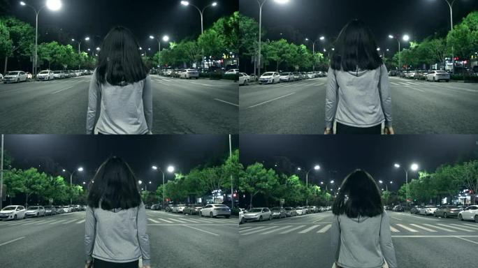 年轻女子晚上独自走在街上