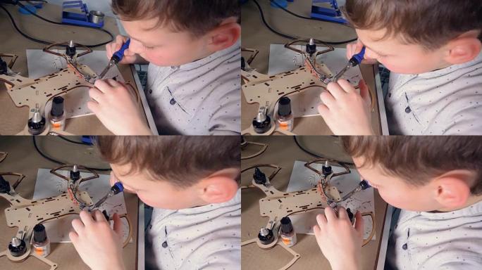 一个孩子正在研究他的现代飞行小工具模型