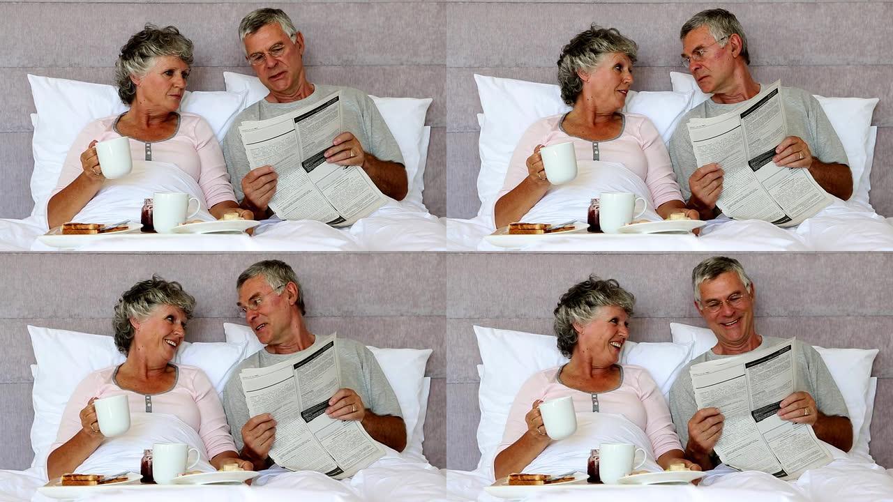 丈夫在早餐时给妻子看报纸