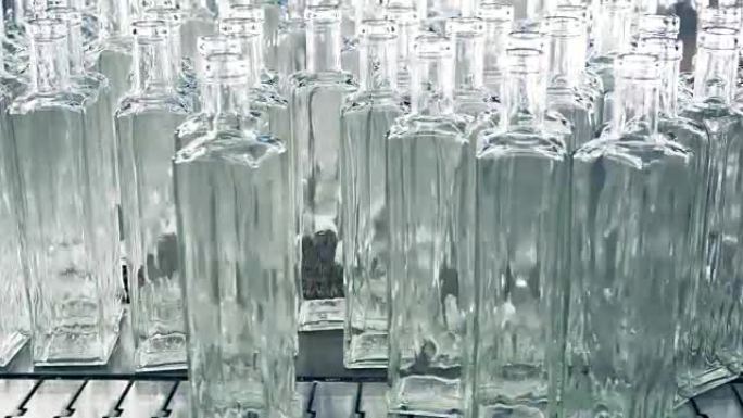 一堆透明的新造瓶子被推到传送带上