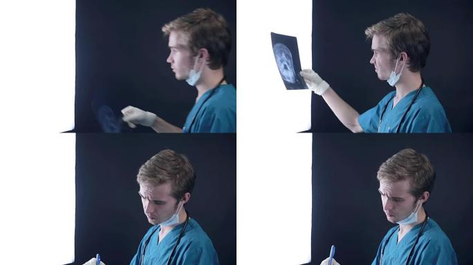 男性医生检查头部的x射线图像