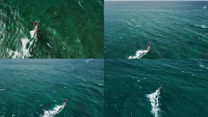 滑过蓝色海洋的风帆冲浪者的鸟瞰图