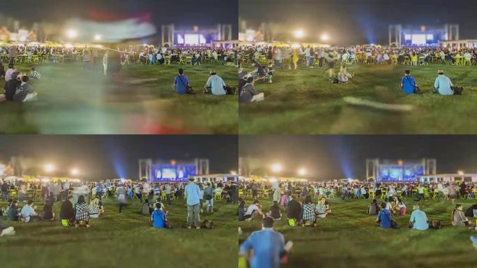 晚上人们在草地上放松，看音乐。