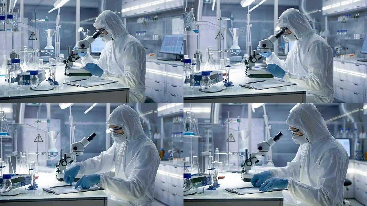 在安全的高水平研究实验室中，Coverall的科学家在显微镜下检查培养皿。