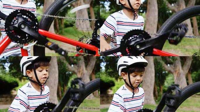 男孩在公园修理自行车