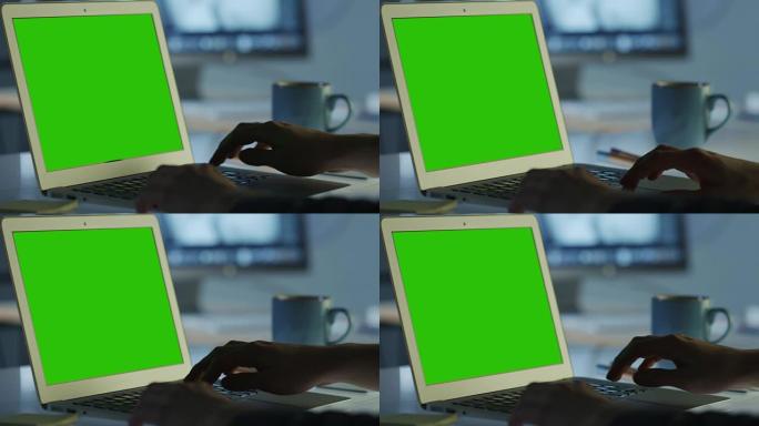 程序员在办公室工作的笔记本电脑的绿屏模型。