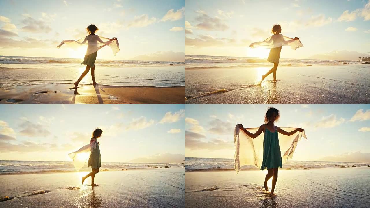 美丽的年轻女子在沙滩上慢动作行走，柔和温暖的复古日落色调
