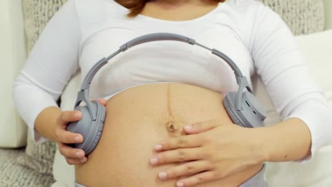 Pregnant woman playing music to her unborn baby th