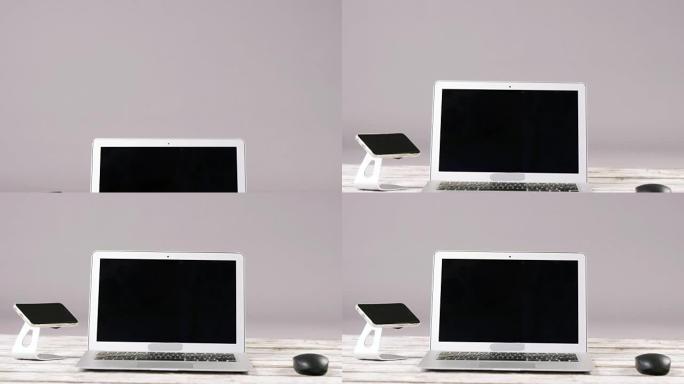 笔记本电脑、带支架和电脑鼠标的智能手机