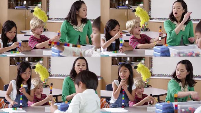 老师与年幼的孩子坐在一起，用R3D拍摄