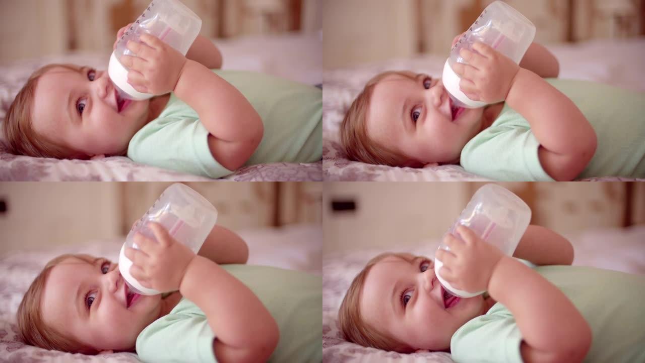 男婴躺下，从瓶子里喝水