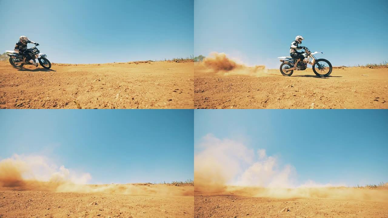 一个骑摩托车的人在沙尘中慢动作地骑着自行车