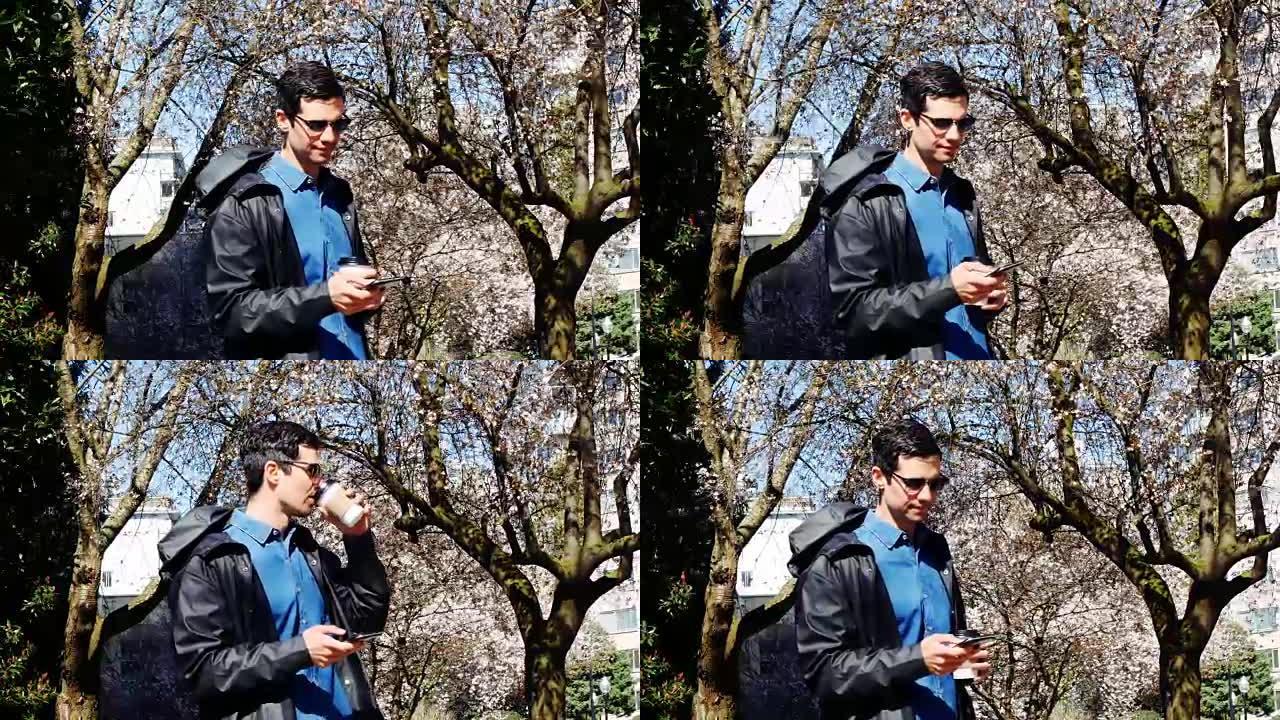 男子在公园4k喝咖啡时使用手机