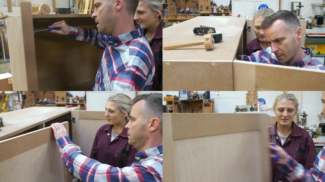 木匠检查女学徒组装橱柜的工作