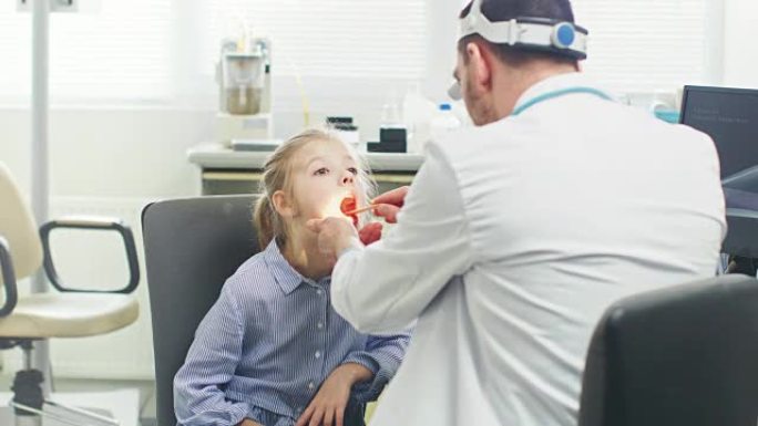 友好的医生检查小女孩的喉咙痛，治愈流感。现代医疗保健，友好的儿科医生和明亮的办公室。