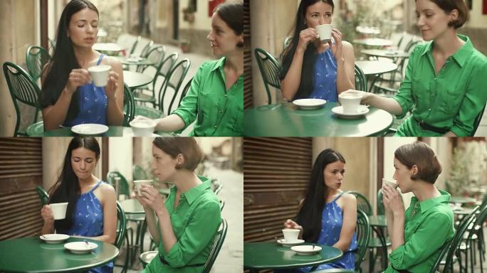 两个穿着浅色夏装的迷人年轻女性在街头咖啡店放松和交谈。