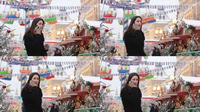 在俄罗斯莫斯科红场的圣诞市场上，冬天站在电话里聊天的女人